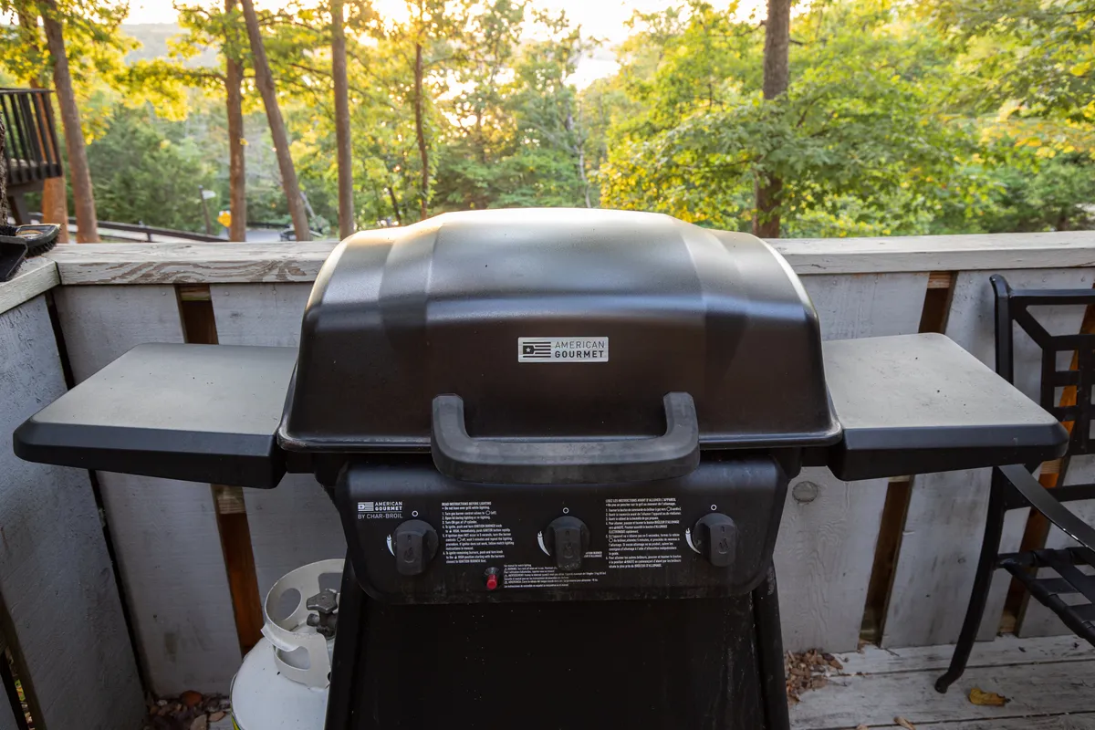 This image captures a welcoming outdoor deck complete with a grill, surrounded by lush greenery—perfect for group barbecues and casual outdoor gatherings. The inviting setup and warm ambiance highlight the space's suitability for celebrating special occasions with friends and family.
